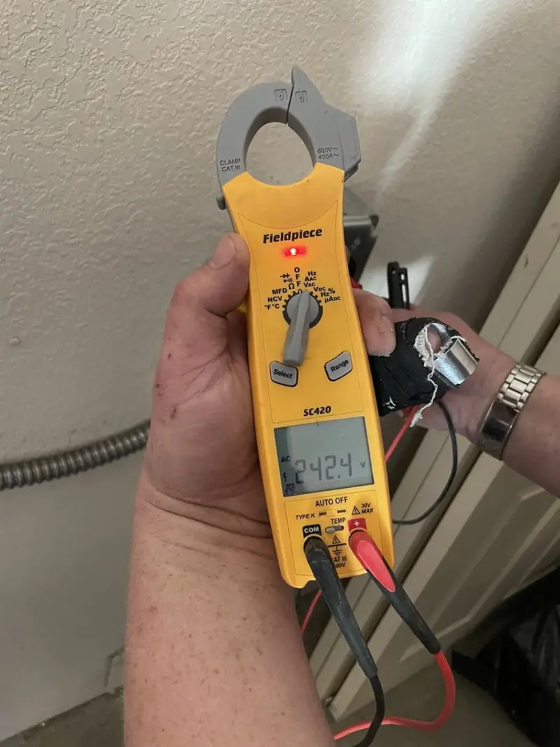 Voltage testing with clamp meter during Recessed Lighting Installation in Champaign